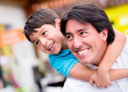 10 Ways to Tell Your Kids You Are Proud of Them Happy father playing with his son and smiling