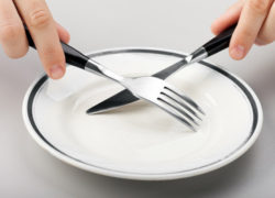 How Fasting Can Radically Change Your Life Forever (Newsletter 2-12 Article) Hungry person hand holding fork knife on food plate