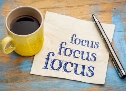 Focus on Focus (Newsletter 3-4) Focus concept - handwriting on a napkin with a cup of espresso coffee
